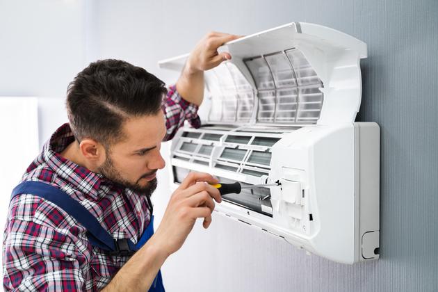 Repairer Repairing Air Conditioner